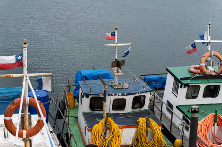 Fishing boats flying Chilean flags in southern marinaの写真素材