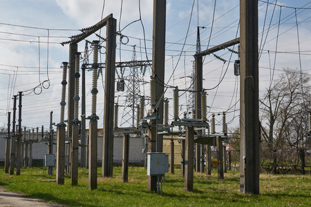 Electric poles with wires and insulators on electrical substation