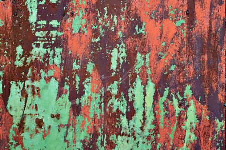 Rusty metal plate painted in green and red colorsの写真素材