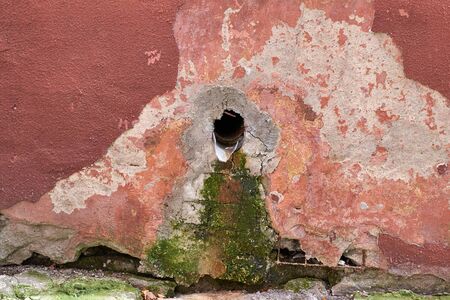 drain the old rusty pipe sticking out of the walls are plastered redの写真素材