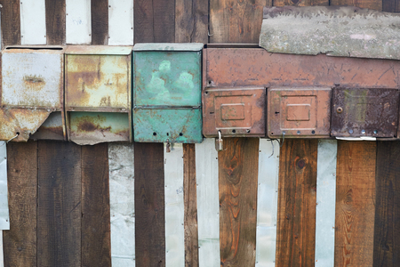 colorful old mailboxes on wooden baseの写真素材