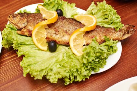 Grilled trout with lemon, dill and salad leavesの写真素材