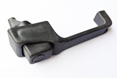Plastic truck door handle on isolated white background. New spare part close-up.の写真素材