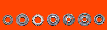 Metal gears isolated on lush lava background collage. Steel industrial gears banner with copy space for text. Trendy color 2020. Spare parts.の写真素材