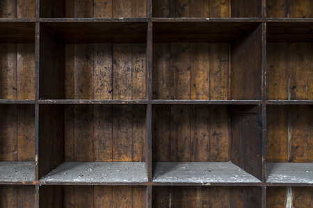 An old and distressed, dark wood shelf. Made of empty boxes covered with dust and dirt.の写真素材