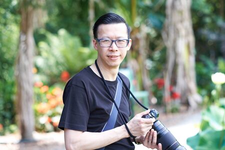 man holding camera in park