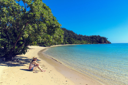 woman sitting on beach in Fijiの写真素材