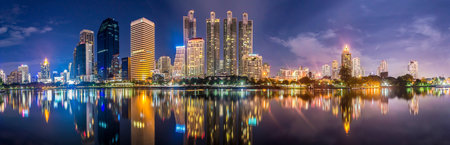 Night lights from skyscrapers reflecting in the water. background