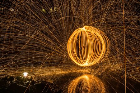 Abstract Image of Burning Wirewool being used to make circle like light trails at Nightの写真素材