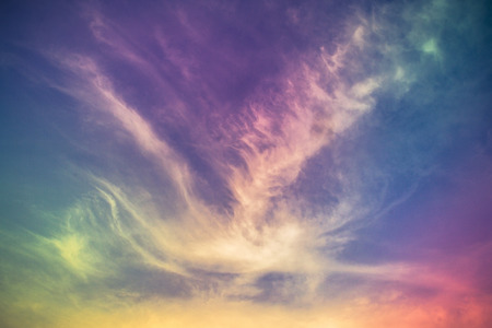 A soft cloud background with a pastel colored orange to blue gradient.の写真素材