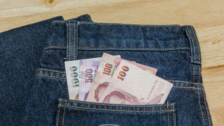 Thai money ready to travel On the background Jeansの写真素材