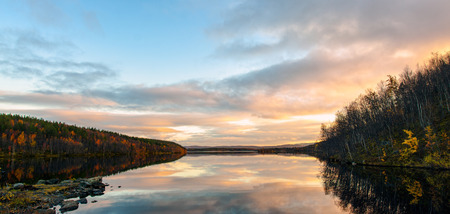 Sunset and clouds above the lake in autumnの写真素材