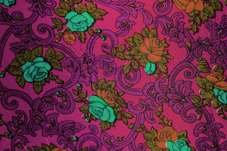 Fragment of colorful retro tapestry textile pattern with floral ornament useful as backgroundの写真素材