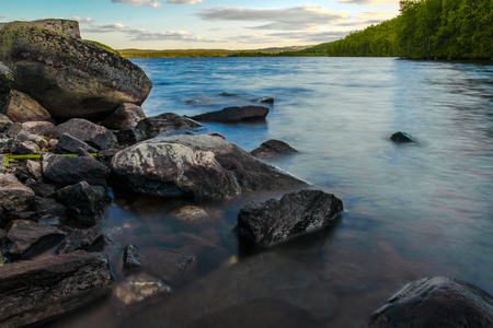 Summer landscape. A large lake in the forest above the Arctic circle, Russia.Long exposureの写真素材