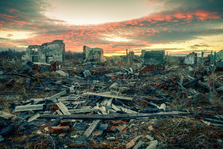 The remains of destroyed houses at sunset.Apocalyptic landscapeの写真素材