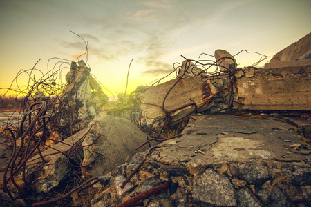 The debris of the damaged building on sunset sky backgroundの写真素材