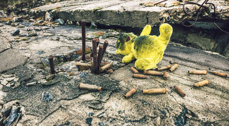 Old toy and ammunition in the wreckage of the buildingの写真素材