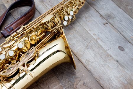 golden saxophone on table wooden backgroundの写真素材