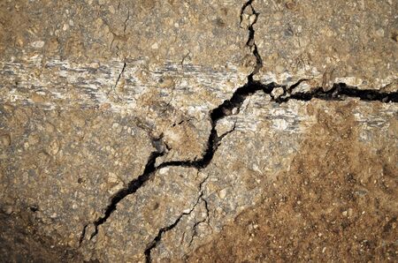 the texture of the damaged asphalt with crackの写真素材