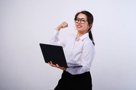 Photo of of excited happy Asian businesswoman looking at laptop screen on isolated white backgroundの写真素材