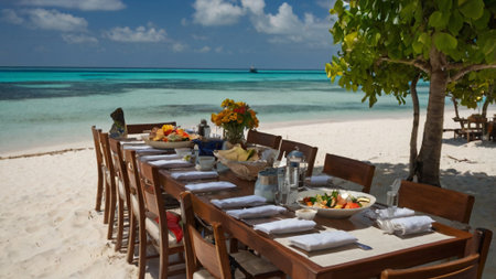 Table set for a romantic dinner on a tropical beach in Maldivesの写真素材