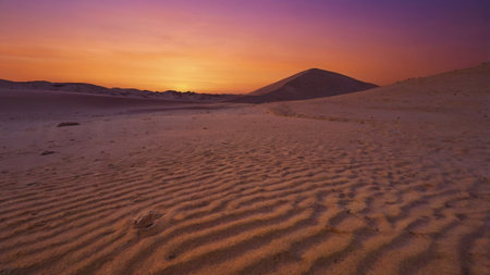 Sunset over the sand dunes in the Sahara desert, Moroccoの写真素材