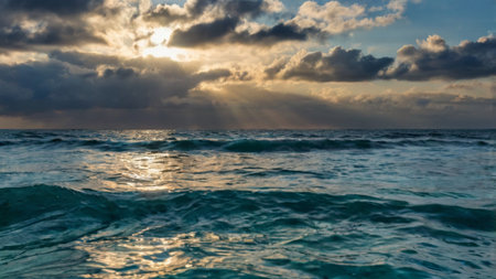 beautiful seascape with clouds and sunbeams in the skyの写真素材