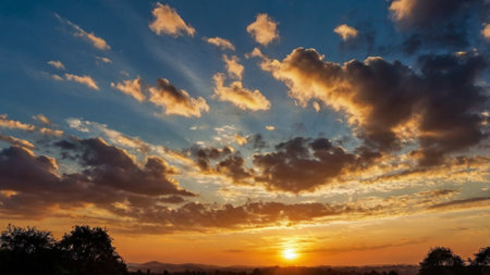 Sunset sky background with clouds and sunbeams. Nature composition.の写真素材