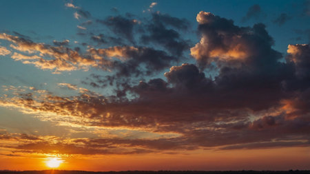Sunset over the field. Beautiful sky with clouds at sunset.の写真素材