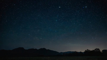 Night sky with stars and milky way over mountain range. Natural background.