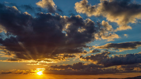 Beautiful sunset over the sea. Colorful sky with clouds and sun