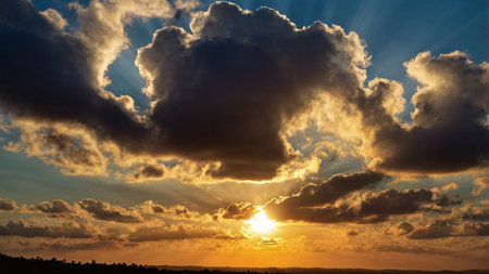 Sunset with dramatic clouds and rays of light shining through the cloudsの写真素材