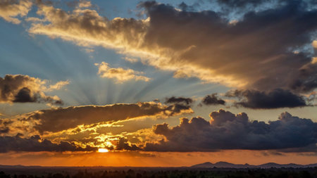 Sunset sky with clouds and sunbeams. Nature background.の写真素材