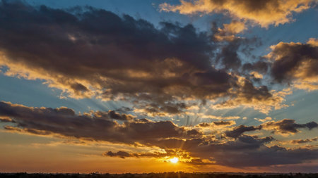 Sunset sky with clouds and sunbeams. Nature composition.