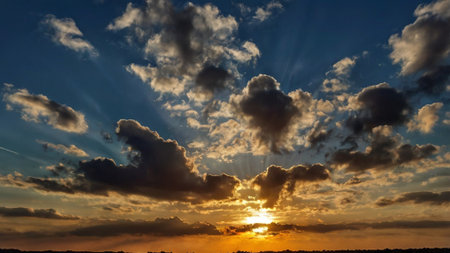 Sunset sky with clouds and sun rays. Beautiful nature background.の写真素材