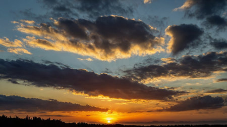Sunset sky with clouds. Beautiful nature background. Dramatic sky.の写真素材