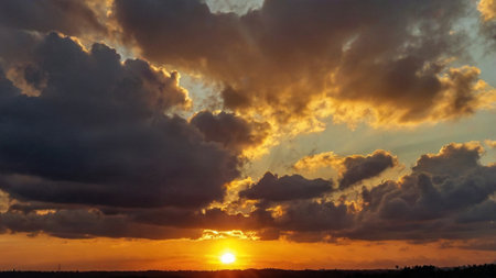 Dramatic sunset sky with clouds and sun rays. Nature background