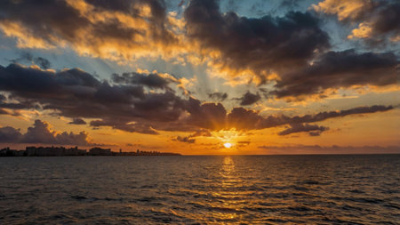 Sunset over the sea. Beautiful sunset over the sea. The sun breaks through the clouds.の写真素材