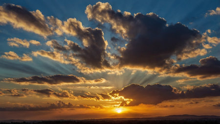 Sunset sky with clouds and sunbeams. Nature background.