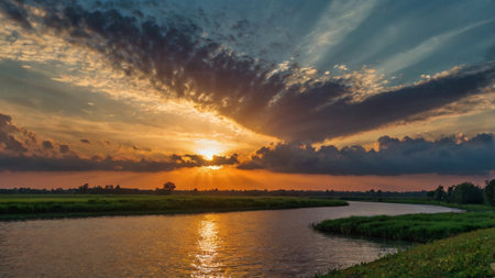 Sunset over the river in summer. Landscape with river and cloudsの写真素材
