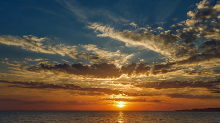 Sunset over the sea. Beautiful sunrise over the sea and skyの写真素材