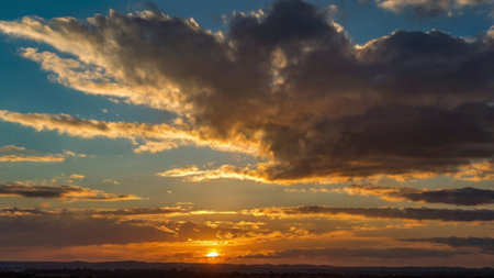 Dramatic sunset sky with clouds over the city. Beautiful nature background.