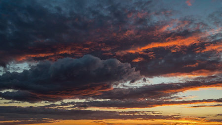 Cloudscape, Colored Clouds at Sunset near the Ocean on a Cloudy Dayの写真素材