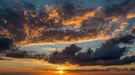 Sunset over the sea with clouds in the sky, summer timeの写真素材