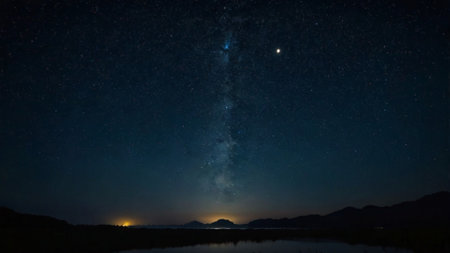 Milky way in the night sky with stars and silhouette of mountain.の写真素材