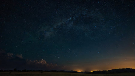 Milky way over the field at night with stars in the sky