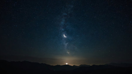 Night sky with stars and moon. Milky way over the mountains.の写真素材