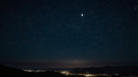 Night sky with stars and milky way over the city. Long exposure
