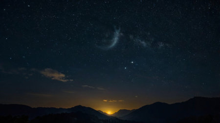 Milky way over the mountains at night. Starry sky.の写真素材