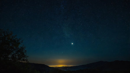 Night sky with stars and milky way over mountain range. Long exposureの写真素材